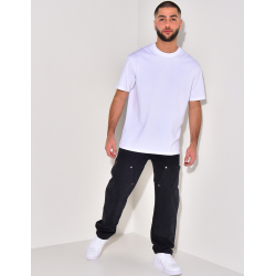 Jeans avec empiècements à motifs en relief