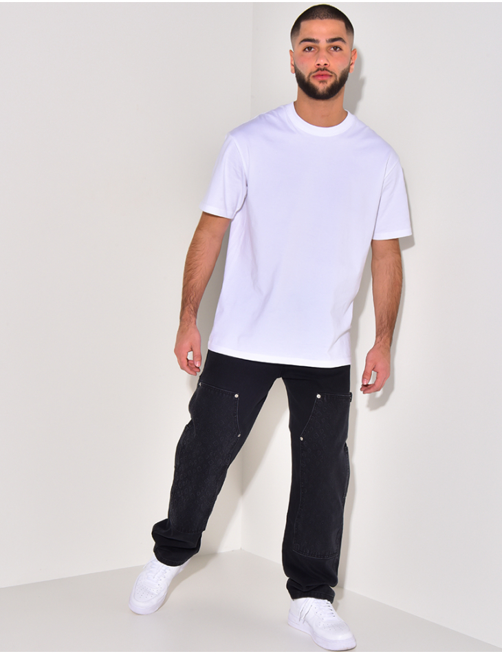 Jeans avec empiècements à motifs en relief