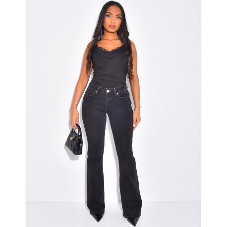 Low-rise flare jeans with rhinestone button pockets at the back