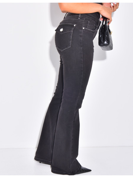 Low-rise flare jeans with rhinestone button pockets at the back