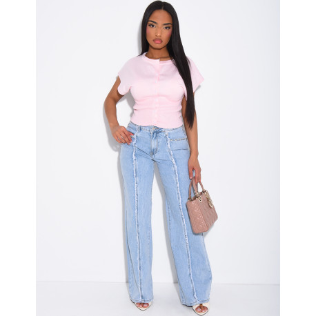 Jeans with frayed seams and studs on the pockets