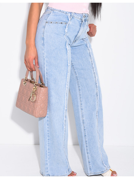 Jeans with frayed seams and studs on the pockets