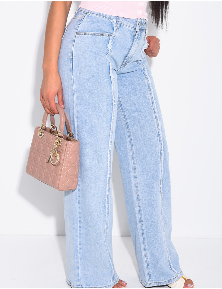 Jeans with frayed seams and studs on the pockets