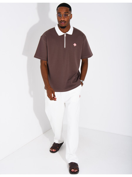 Two-tone set comprising trousers and a polo shirt with a clover logo