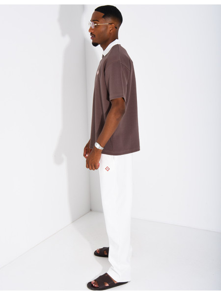 Two-tone set comprising trousers and a polo shirt with a clover logo