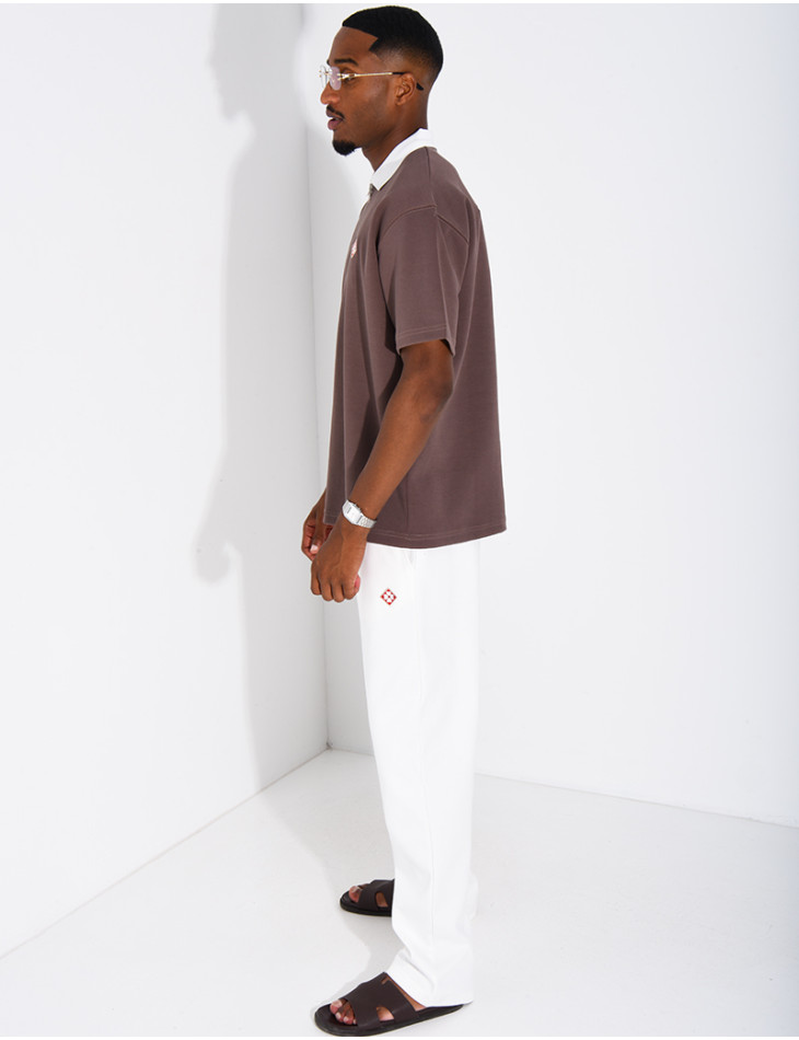 Two-tone set comprising trousers and a polo shirt with a clover logo