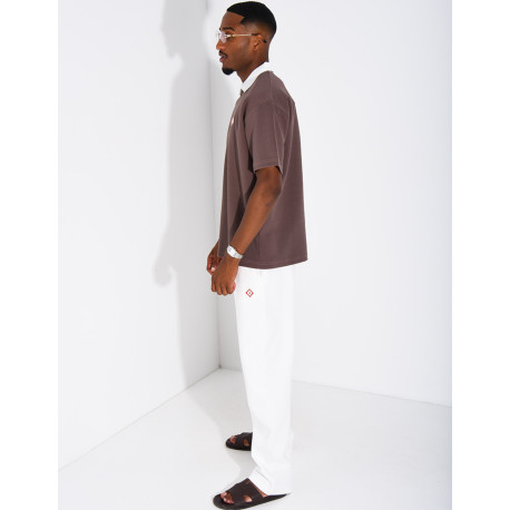 Two-tone set comprising trousers and a polo shirt with a clover logo