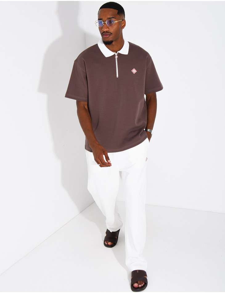 Two-tone set comprising trousers and a polo shirt with a clover logo