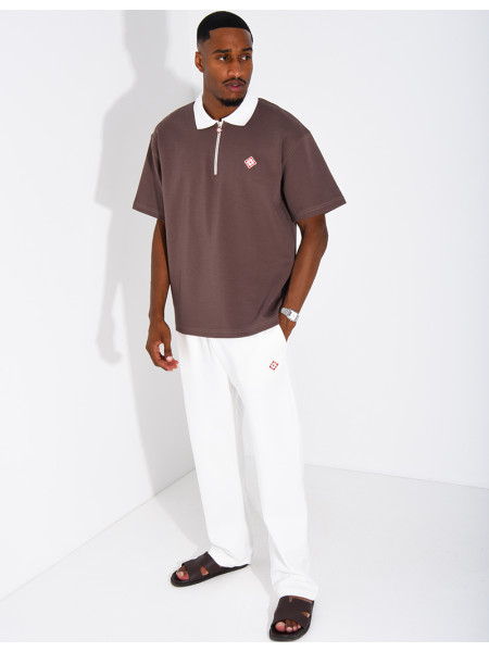 Two-tone set comprising trousers and a polo shirt with a clover logo