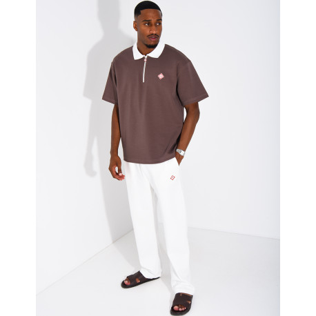Two-tone set comprising trousers and a polo shirt with a clover logo