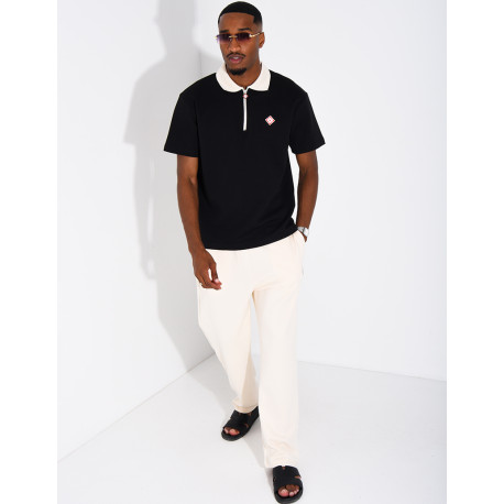 Two-tone set comprising trousers and a polo shirt with a clover logo