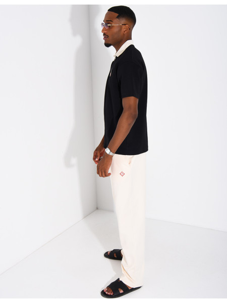 Two-tone set comprising trousers and a polo shirt with a clover logo