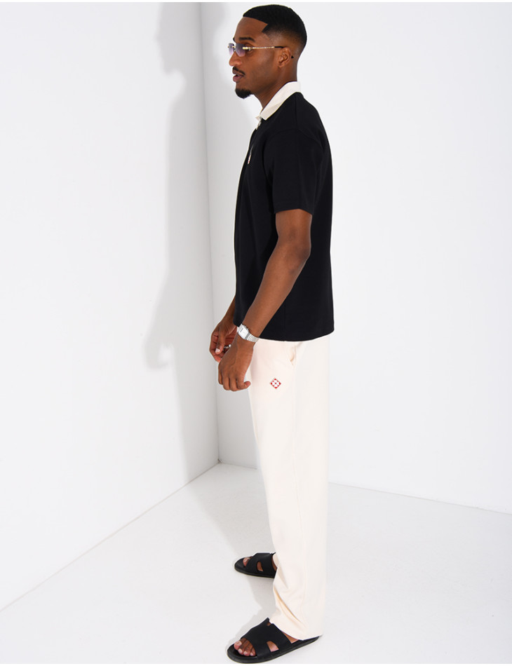 Two-tone set comprising trousers and a polo shirt with a clover logo