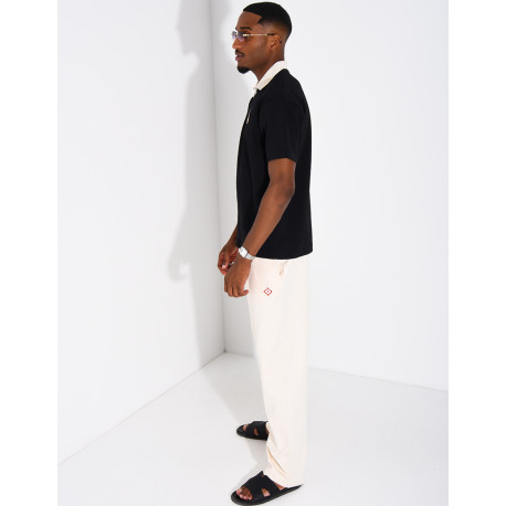 Two-tone set comprising trousers and a polo shirt with a clover logo