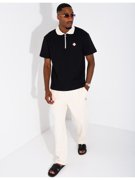Two-tone set comprising trousers and a polo shirt with a clover logo