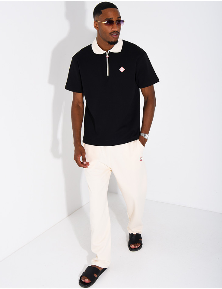Two-tone set comprising trousers and a polo shirt with a clover logo