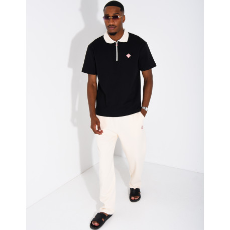 Two-tone set comprising trousers and a polo shirt with a clover logo