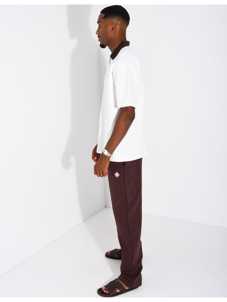 Two-tone set comprising trousers and a polo shirt with a clover logo