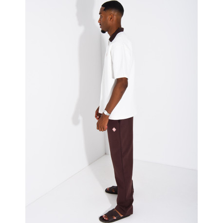 Two-tone set comprising trousers and a polo shirt with a clover logo