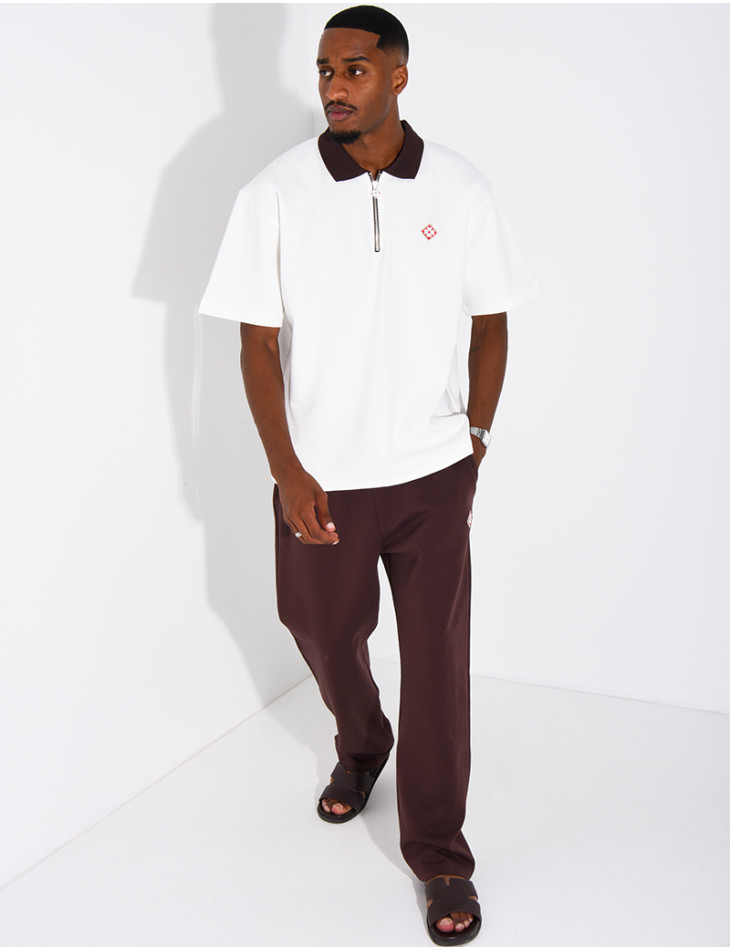 Two-tone set comprising trousers and a polo shirt with a clover logo