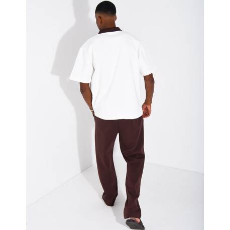 Two-tone set comprising trousers and a polo shirt with a clover logo