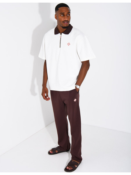 Two-tone set comprising trousers and a polo shirt with a clover logo