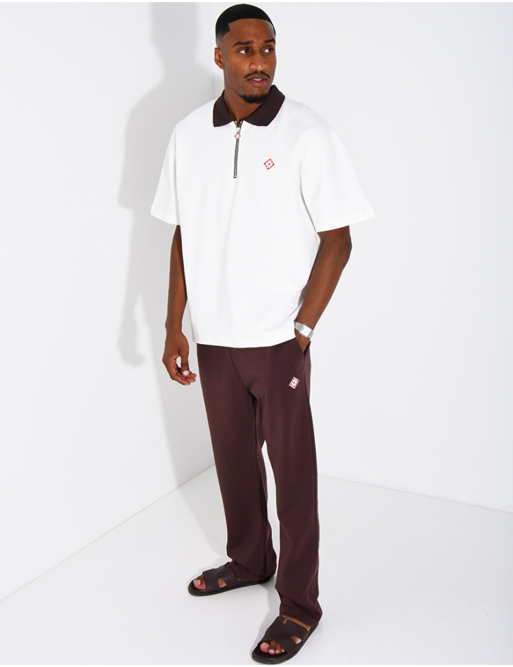 Two-tone set comprising trousers and a polo shirt with a clover logo