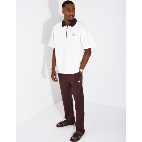 Two-tone set comprising trousers and a polo shirt with a clover logo