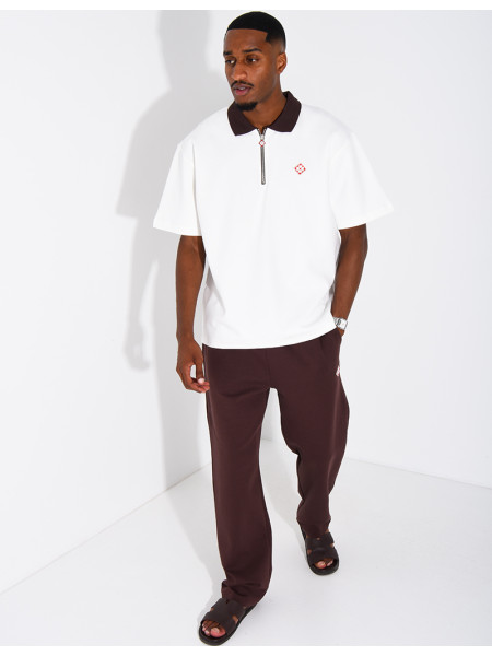 Two-tone set comprising trousers and a polo shirt with a clover logo