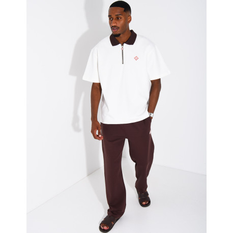 Two-tone set comprising trousers and a polo shirt with a clover logo