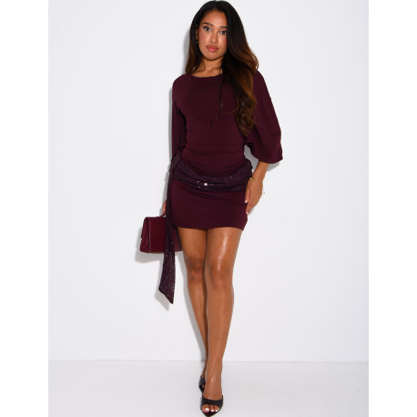 Short, form-fitting dress with a sequined shawl at the waist