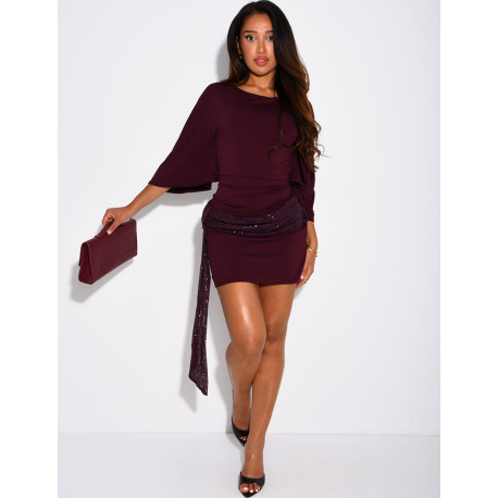 Short, form-fitting dress with a sequined shawl at the waist