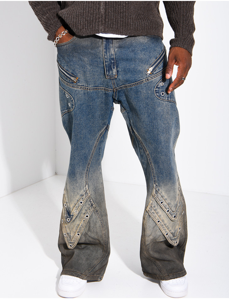 Jeans effet délavé à empiècements et oeillets