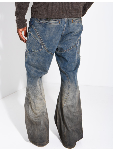 Jeans effet délavé à empiècements et oeillets