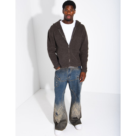 Jeans effet délavé à empiècements et oeillets