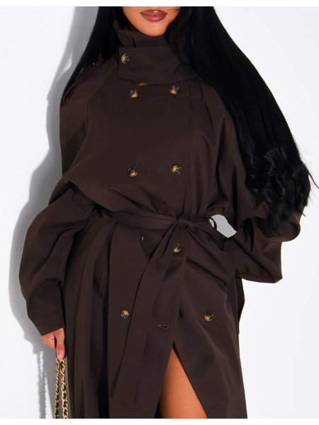 Long, oversized trench coat with a stand-up collar and a belt at the waist