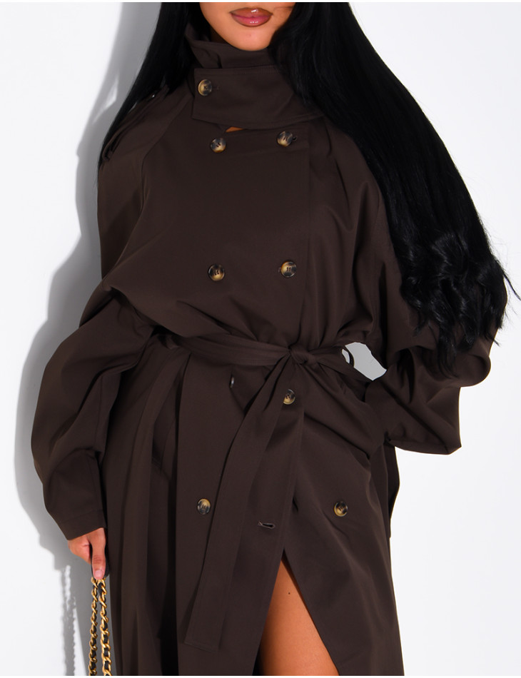 Long, oversized trench coat with a stand-up collar and a belt at the waist