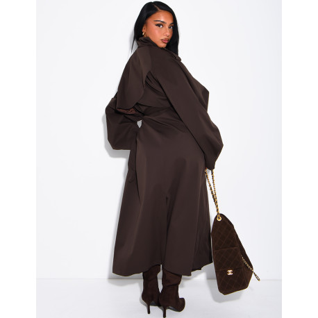 Long, oversized trench coat with a stand-up collar and a belt at the waist