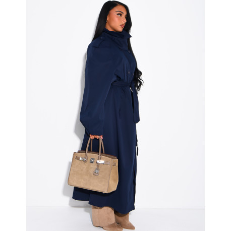 Long, oversized trench coat with a stand-up collar and a belt at the waist