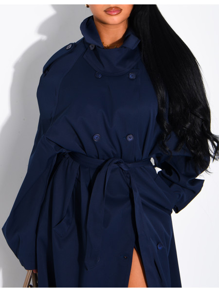 Long, oversized trench coat with a stand-up collar and a belt at the waist