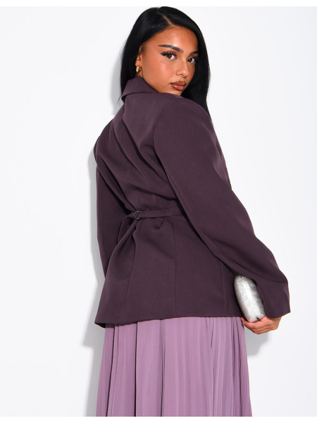 Blazer with an adjustable asymmetrical button placket in the back