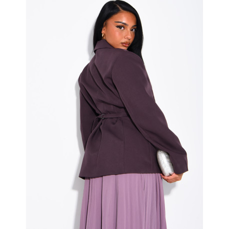 Blazer with an adjustable asymmetrical button placket in the back