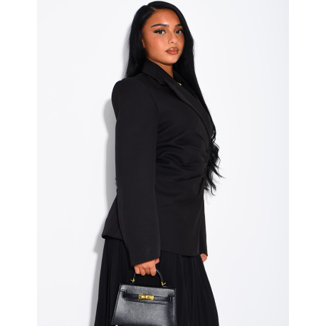 Blazer with an adjustable asymmetrical button placket in the back