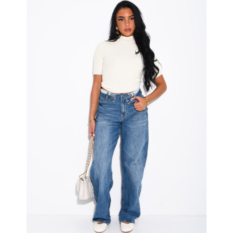 High-waisted, faded blue jeans with turned-up hems at the waist