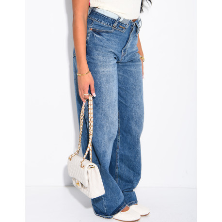 High-waisted, faded blue jeans with turned-up hems at the waist