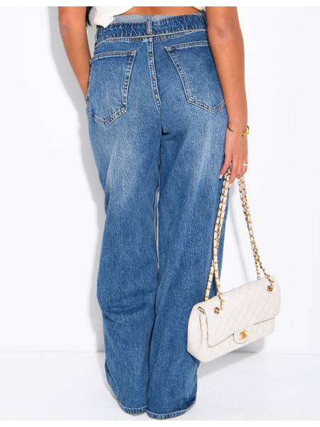 High-waisted, faded blue jeans with turned-up hems at the waist