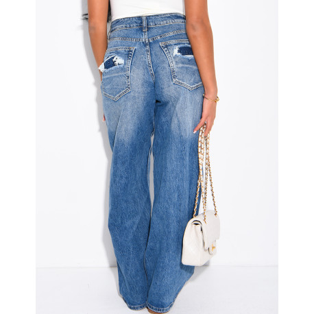 High-waisted, faded jeans with lettering on the pockets